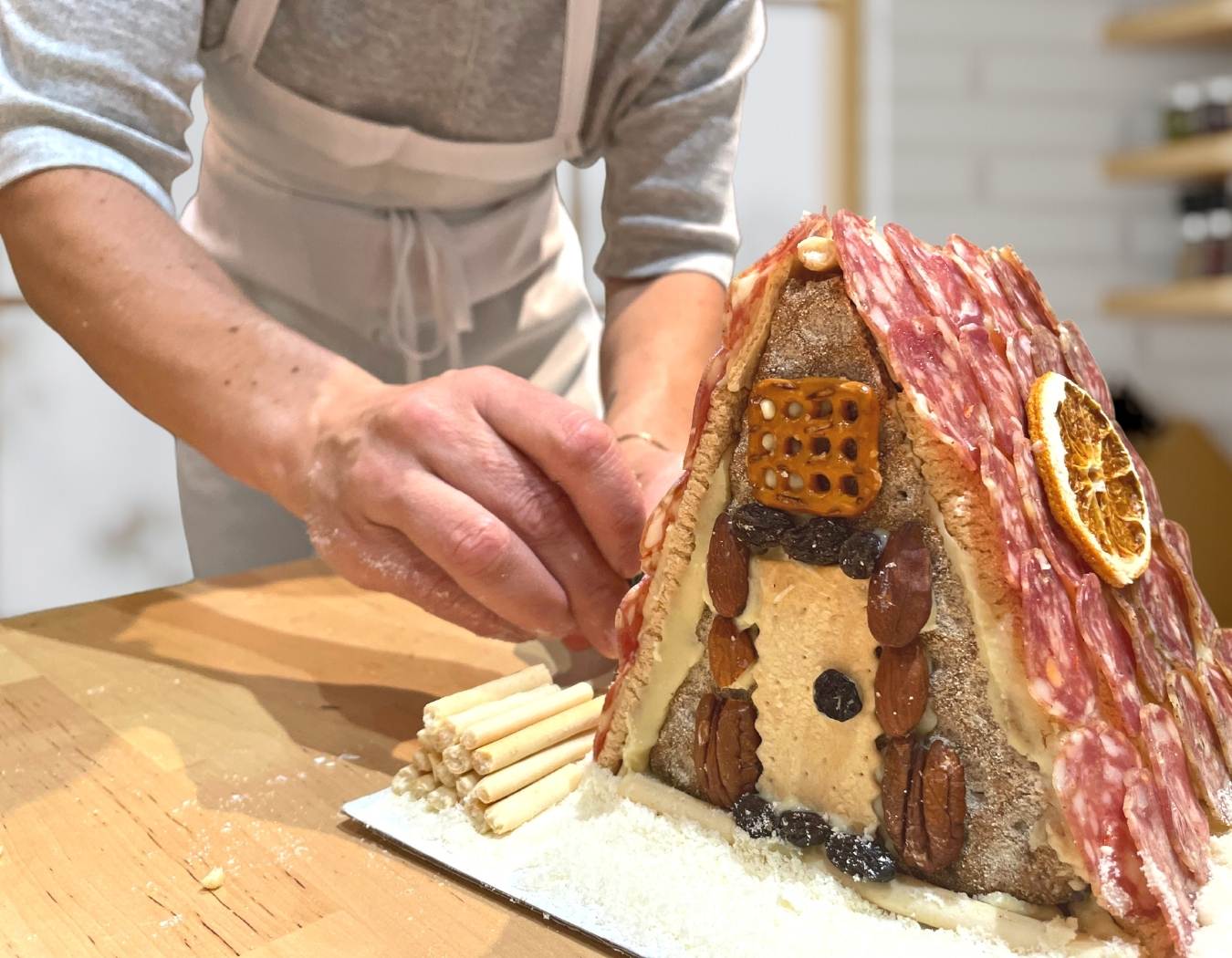 woman decorating charcuterie chalet